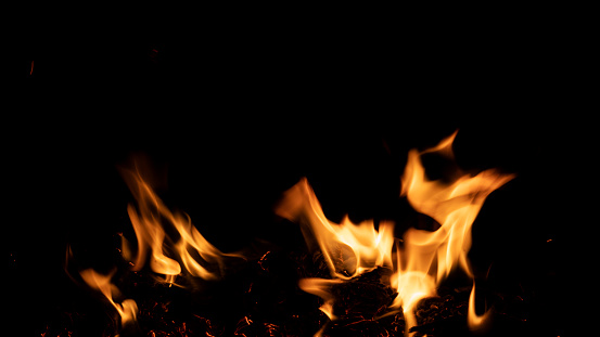 Fire burning on a black background. Ideal for compositing with another image. The background can be removed with a blending mode like screen.