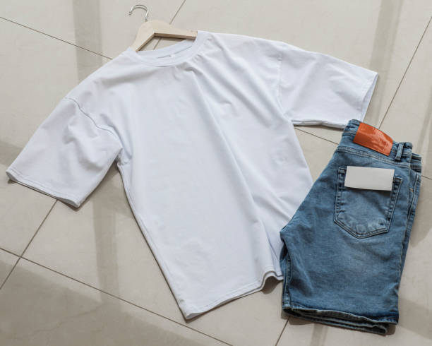 istock White T-shirt on a rack with blue jeans 1331517128