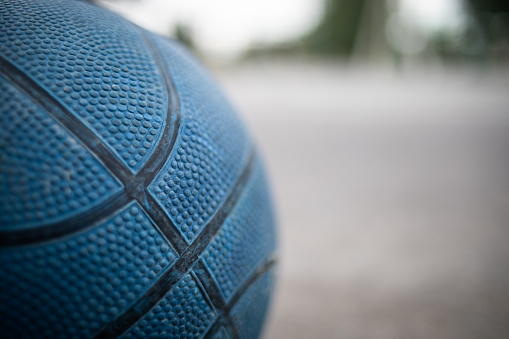 Basketball ball on a concrete court.