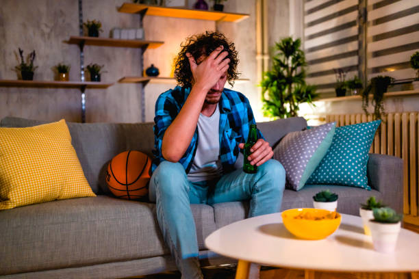 istock Frustrated man watching basketball on TV 1331523264