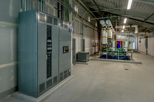 Industrial boiler room with electrical controls.