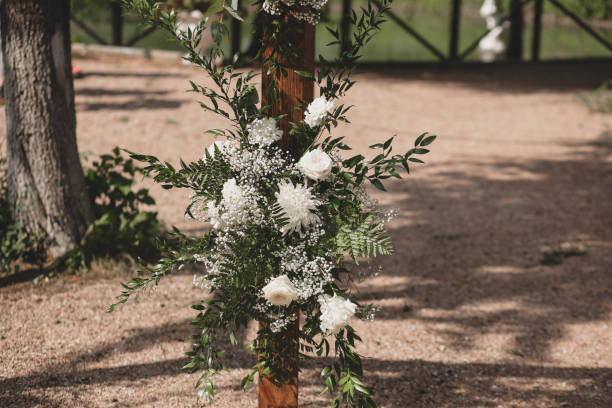 istock Wedding arch on boho style with white flowers in park. 1331524119