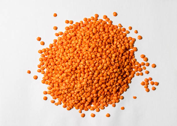 Red lentils on a white background, raw legumes