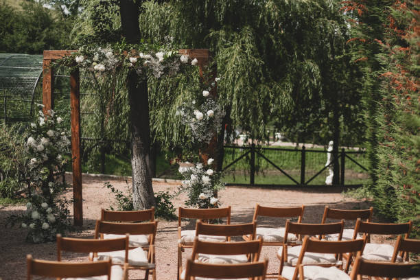 istock Wedding arch on boho style with white flowers in park. 1331524811