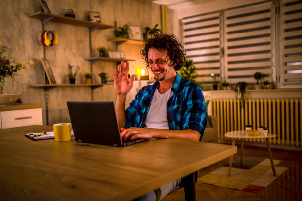 istock Man video chatting on his lap top 1331524820