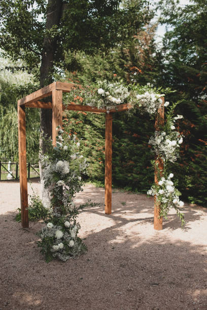 istock Wedding arch on boho style with white flowers in park. 1331524828