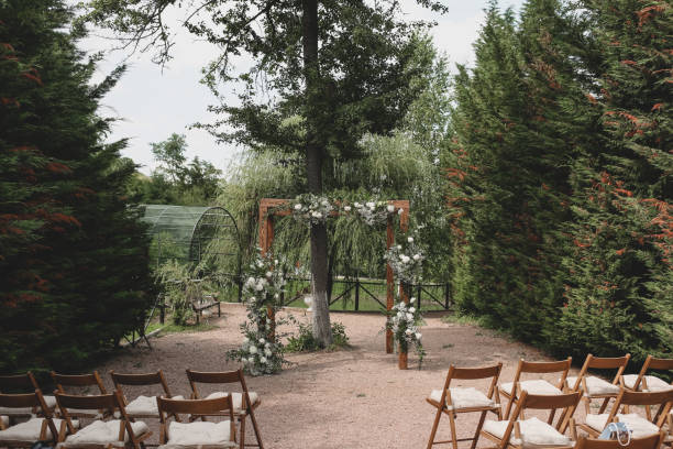 istock Wedding arch on boho style with white flowers in park. 1331524853