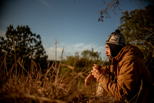 Man drinking mate in the late winter afternoon
