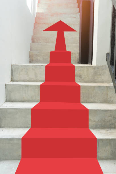 Red arrow pointing up the stairs. stock photo