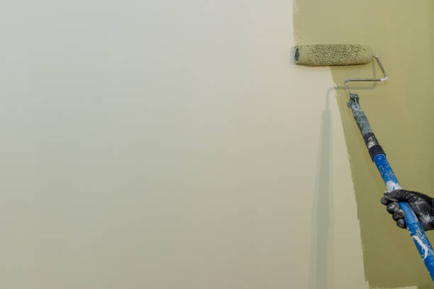istock Worker painting apartment wall on surface wall by the roller brush 1331544234