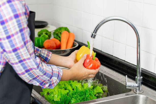 istock Washing vegetables in the kitchen sink 1331545190