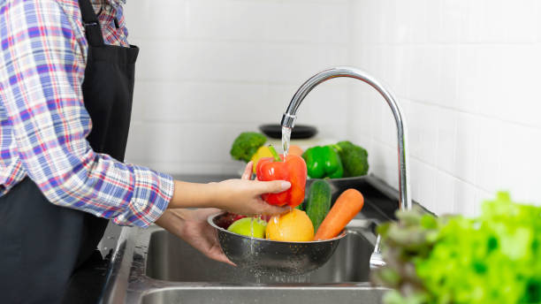 istock Washing vegetables in the kitchen sink 1331545195