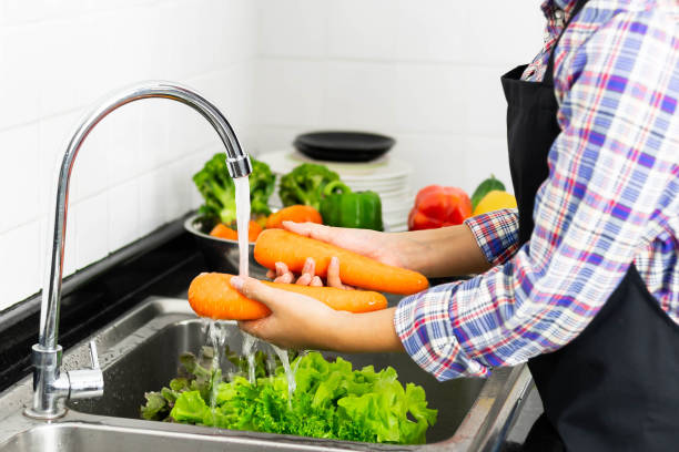 istock Washing vegetables in the kitchen sink 1331545204