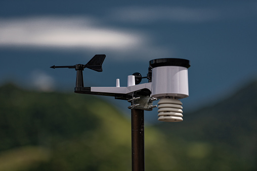 Weather station or meteorological instrument with solar cell system to measure wind speed, rain precipitation, temperature, atmospheric pressure. Selective focus.