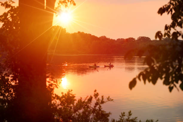 People canoeing on lake during heat wave