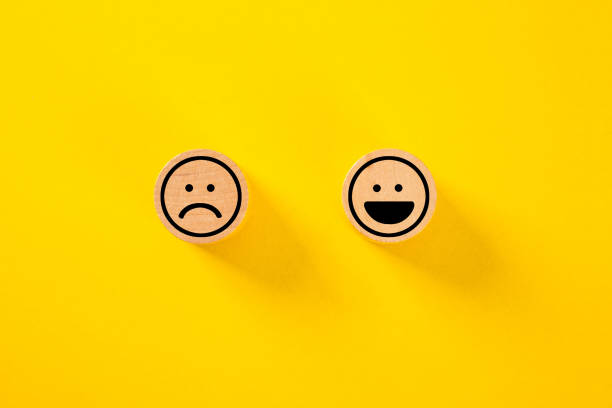 istock Customer choose smiley face and sad face icon on wood cube, Service rating, satisfaction concept., Service rating, satisfaction concept. 1331562108