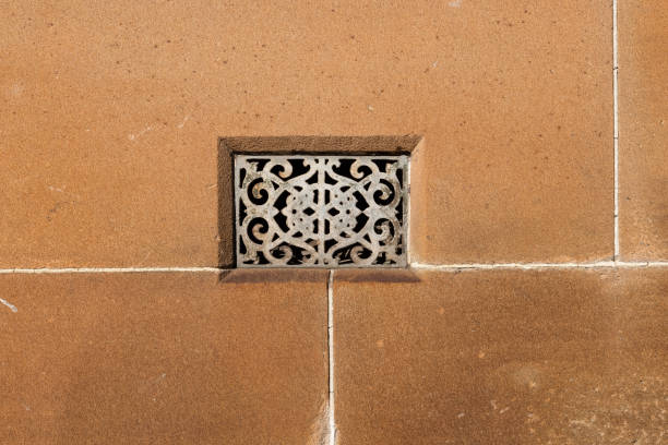 White air vent in an old wall Metal air vent in a sandstone wall. metal grate photos stock pictures, royalty-free photos & images