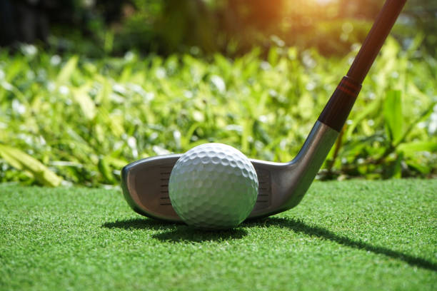 istock Golf balls on the golf course with golf clubs ready for golf in the first short. 1331570599