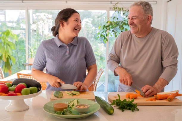 istock Eurasian Daughter and Caucasian Father Laughing While Preparing Vegan Dinner 1331571701
