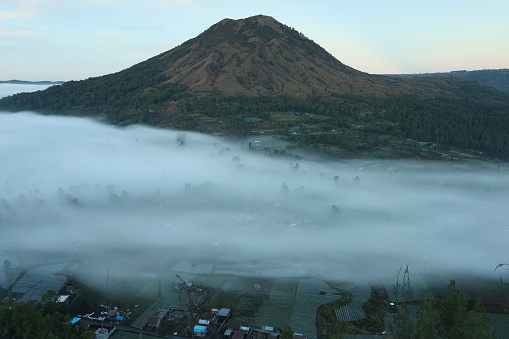 Morning mist-covered countryside in the valley of Mount Batur, Bali, Indonesia