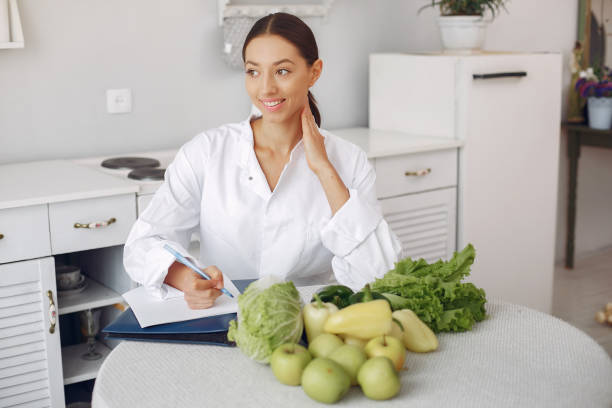 istock Beautiful doctor in a kitchen with a vegetables 1331574076