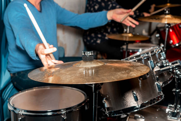istock Male drum player hands holding cymbals with both hands and sticks. Drummer 1331576288