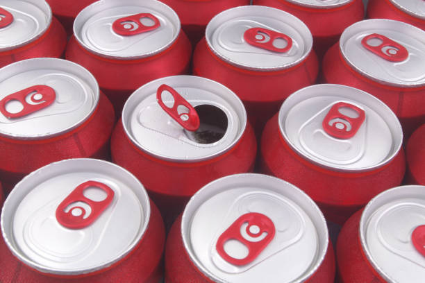 istock Red tin cans close up. Many closed beer cans, one can opened. 1331581607