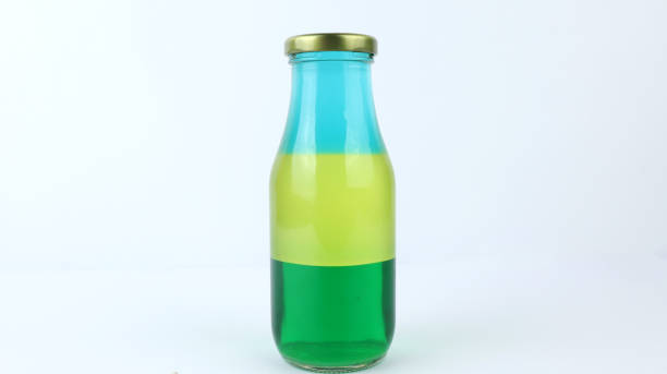 istock Liquid or layer density experiment using 3 separate layers consisting of water, olive oil and alcohol on the top layer on the bottle. The science concept of density 1331582679