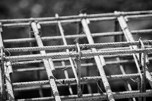 Shallow depth of field (selective focus) image with steel used for reinforcing concrete, on a construction site.