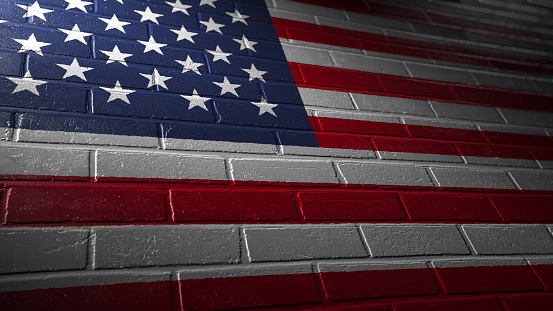 painted flag of the United States of America on a brick wall