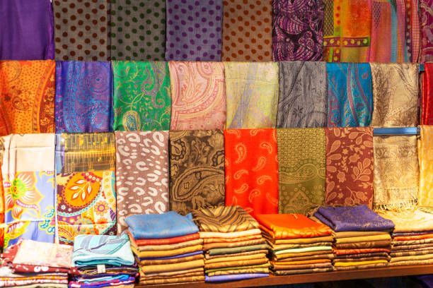 Beautiful patterned on the Southeast Asian style garment;  batik and clothing for sale Various choice of colorful Malaysian traditional hand painted Batik fabric for sale at local market stall batik indonesia stock pictures, royalty-free photos & images