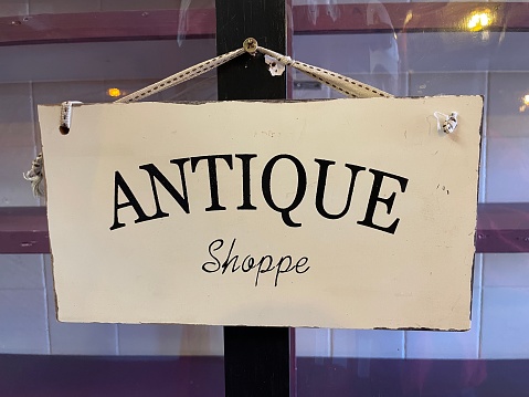 A wooden antique shop sign