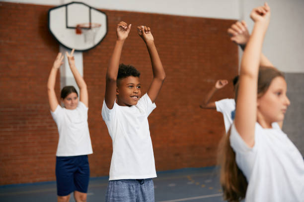 istock Happy African American schoolboy exercising during PE class. 1331594973