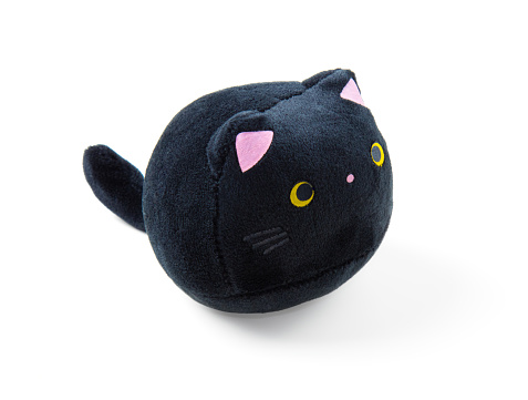 Soft children's toy fluffy black cat isolated by white background.