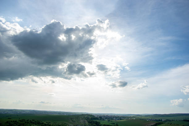 istock Summer landscape and white clouds over green fields 1331598781