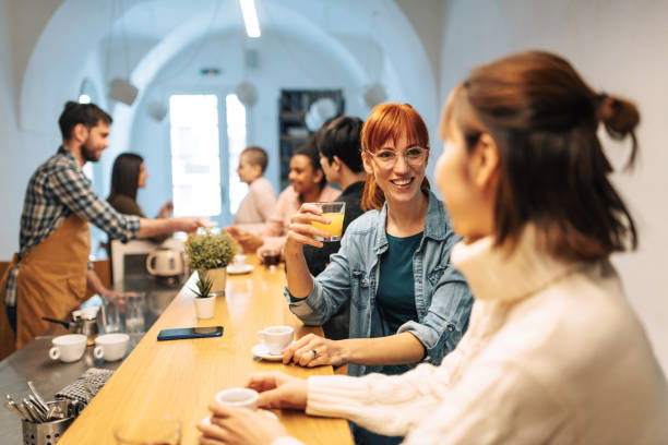 istock Multi ethnic group of people in cafe sitting and talking while bartender serving them 1331602797