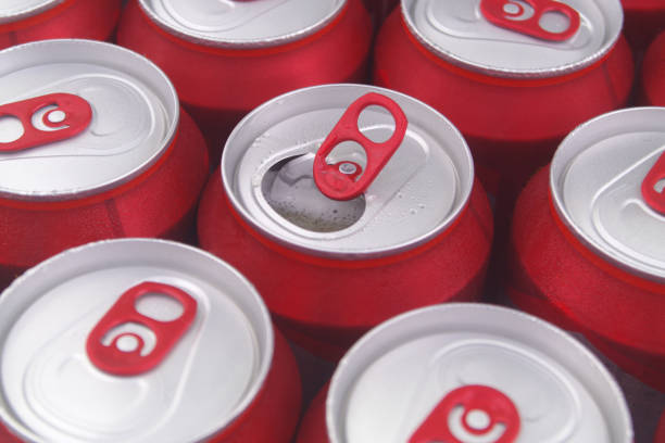 istock Red tin cans close up. Many closed beer cans, one can opened. 1331603341