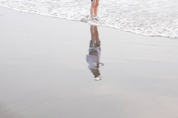 istock Girl standing on the beach. 1331605253