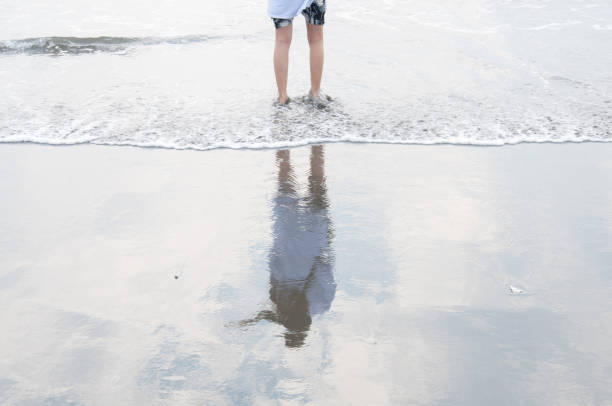 istock Girl standing on the beach. 1331605262