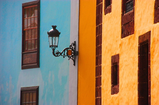 Antique street lantern on the multicolored buildings of Santa Cruz, Tenerife, Canary Islands, Spain