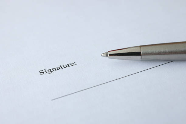Document and pen for signing are on table. Signing contracts and agreements concept