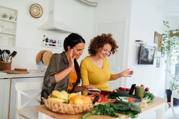 Two Caucasian female friends preparing a nutritional breakfast at home
