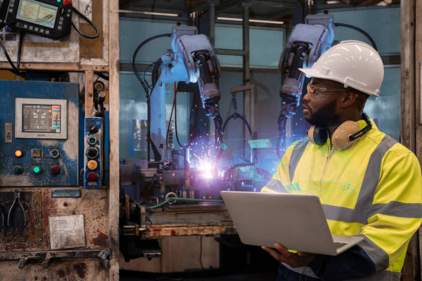 istock Engineer check and control automation robot arms.Robot arms machine in intelligent factory industrial on monitoring system software. Welding robotics and digital manufacturing operation. 1331616222