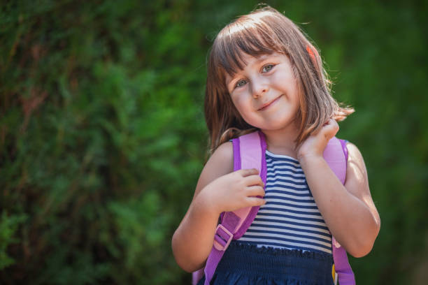 istock Adorable young kindergarten student standing outdoors 1331620012