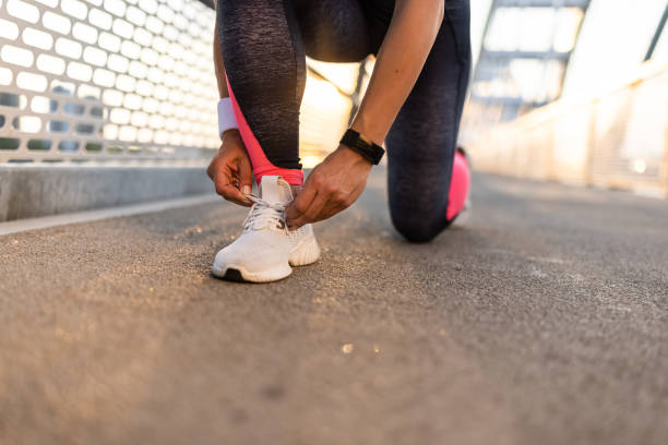 istock Woman tying her sport shoe 1331620301