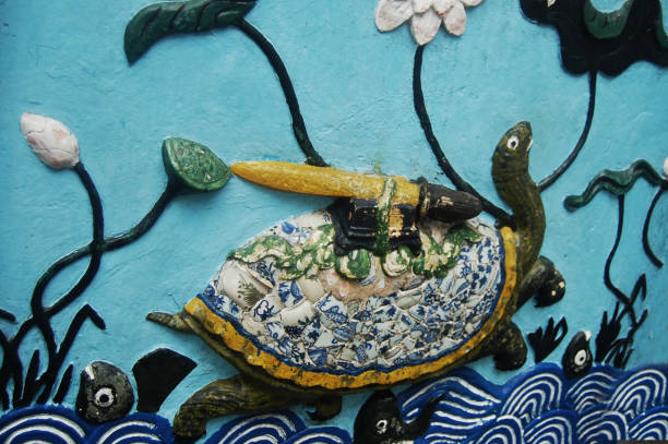 Art sculpture stone carving turtle with a sword on its back on wall gate of Ngoc Son shrine temple in Hoan Kiem lake garden park for vietnamese people foreign travelers travel visit in Hanoi, Vietnam