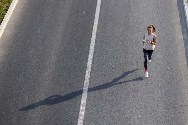 istock Young woman jogging on the road 1331623711