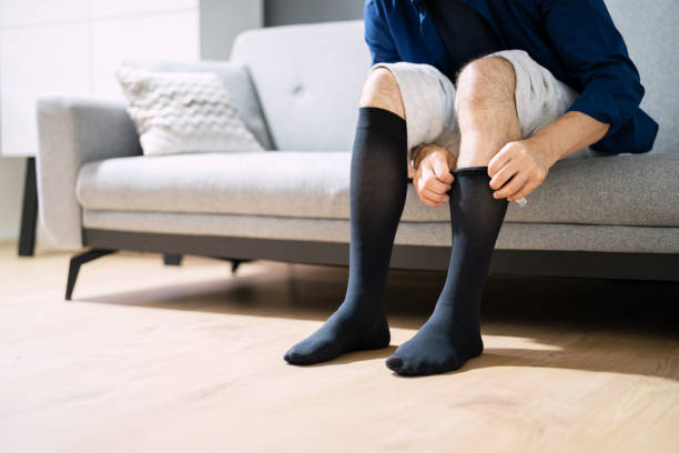istock Man Putting On Medical Compression Stockings 1331625776