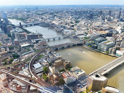 Aerial view over River Thames bridges, London, England, UK. Distinctive, well-maintained  architecture charts the history and development of the capital city with its famous London Landmarks in Summer, England, UK.