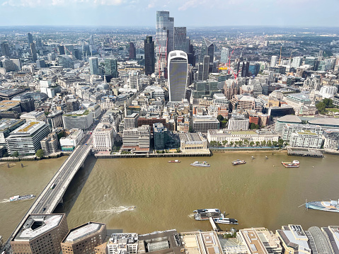 Aerial view looking north over River Thames , London, England, UK. Distinctive, well-maintained  architecture charts the history and development of the capital city with its famous London Landmarks in Summer, England, UK.